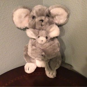 A mama mouse with her detachable baby clutched to her chest.